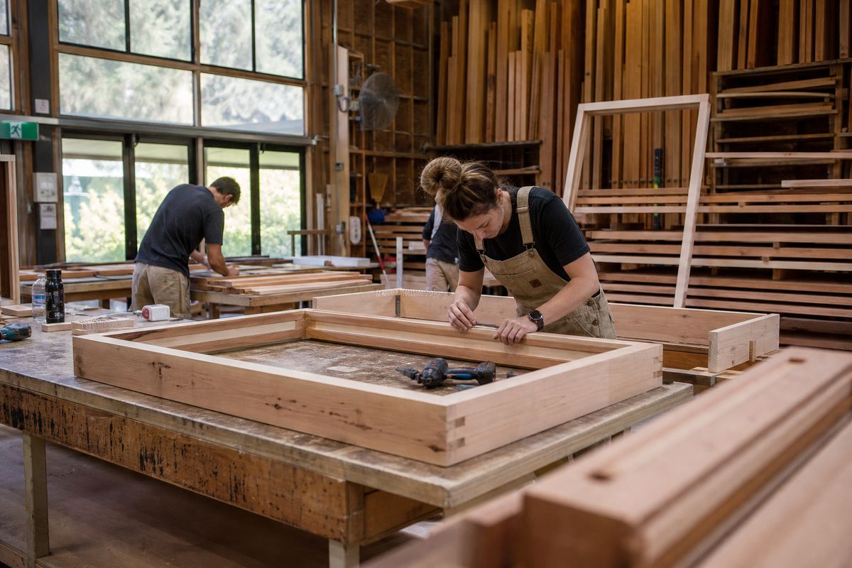 Craftspeople assembling custom timber window frames in an Australian joinery workshop